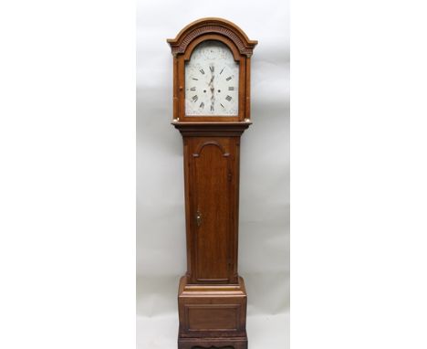 A 19TH CENTURY OAK LONGCASE CLOCK, having arch top hood flanked by column, trunk with arch top door, base on bracket feet, fi