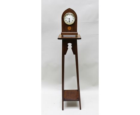 AN EDWARDIAN MAHOGANY LANCET CASED MANTEL CLOCK, having 8-day French movement, with Roman enumerated dial, raised on brass ba