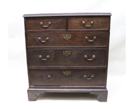 A GEORGE III OAK CHEST OF TWO SHORT OVER THREE LONG GRADUATED DRAWERS with brass swan neck handles and decorative pierced bra