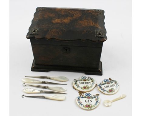 A VICTORIAN PAPIER MACHE TEA CADDY, the shaped, hinged cover with decorative metal mounts, opens to reveal two inner compartm