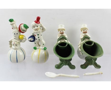 TWO CONTINENTAL CERAMIC TABLE SALTS, modelled as children sat upon coal scuttles, one with spoon, 9.5cm high, together with T