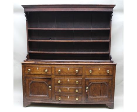 A 19TH CENTURY OAK DRESSER, the base fitted with three drawers over a central bank of three smaller drawers, flanked by two c