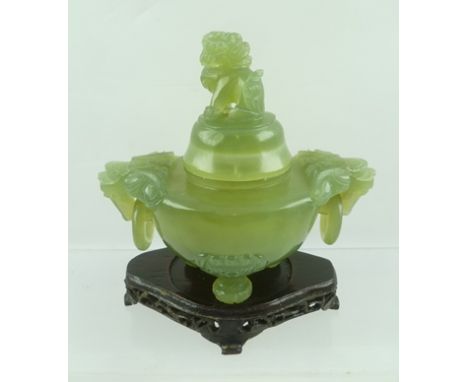 A 20TH CENTURY CHINESE CARVED JADE CENSOR, the cover with Dog of Fo finial, the body with lion ring mask handles, raised on t