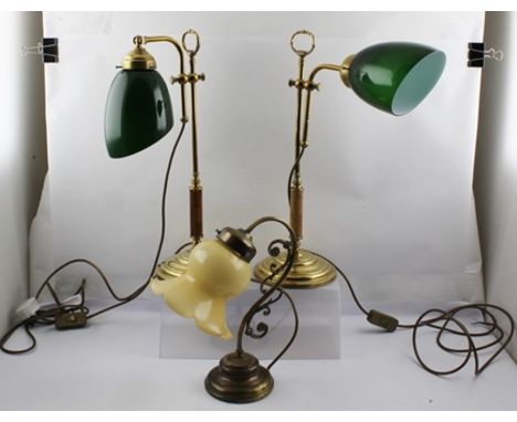 A PAIR OF ADJUSTABLE BRASS TABLE OR DESK LAMPS, with opaque green glass shades, together with a small decorative brass TABLE 