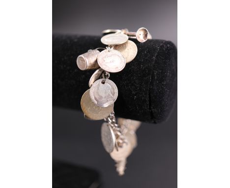 A vintage silver coin / charm bracelet, 53 g