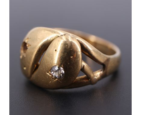 A diamond-set high carat yellow metal double-serpent ring, (one stone lacking), 7.3 g