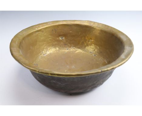 A hand beaten brass basin bearing struck ownership marking "W M Clark ESQ", mid 19th Century, 42 cm 