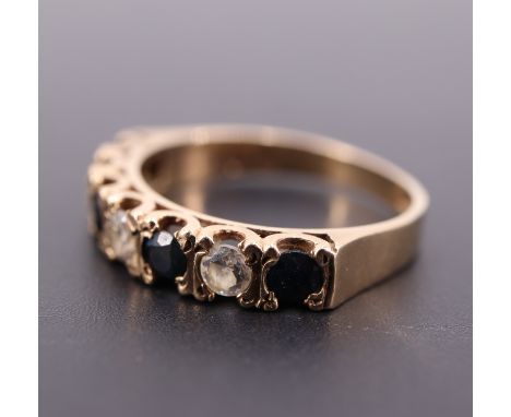 A sapphire and cubic zirconia half hoop eternity ring, the stones set on 9 ct gold, N/O, 2.5 g