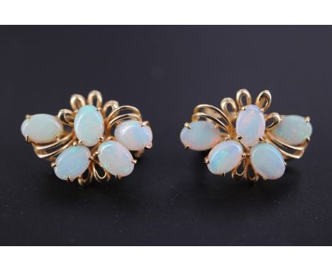 A pair of late 20th Century opal and 14 ct gold earrings, each comprising an asymmetric arrangement of five oval cabochons cl