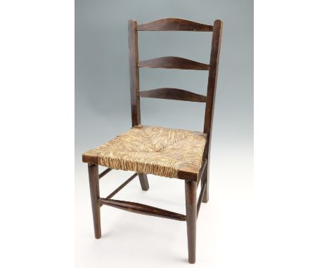 A child's rush-seated ladder-back chair, 66 cm