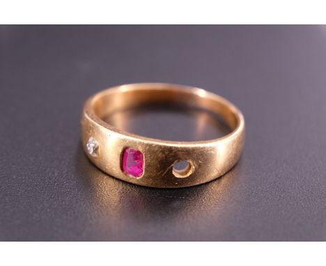 An 18 ct yellow metal, diamond and pink stone finger ring, the stones sunken set on a broad tapering band, (a/f), M, 3.7 g