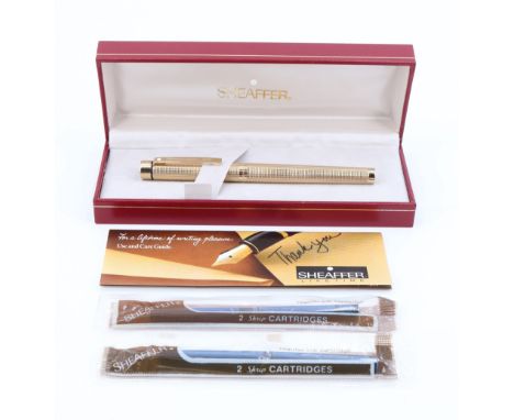 A 1970s cased Sheaffer gold electroplated fountain pen, having a Sheaffer "14K" nib, together with two original ink cartridge