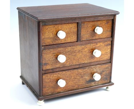 Victorian mahogany miniature chest of drawers having ceramic knobs and feet, 20 cm x 14 cm x 20 cm 