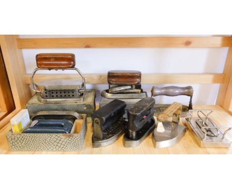 Nine various vintage solid fuel and other travel irons, including 'Fuluse' iron / accessory heater, and a rattan handled and 