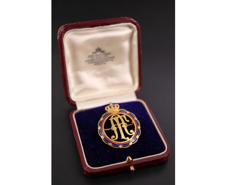 An early 20th Century enamel and yellow metal brooch, having an openwork monogram, possibly that of Friedrich Augustus III, w
