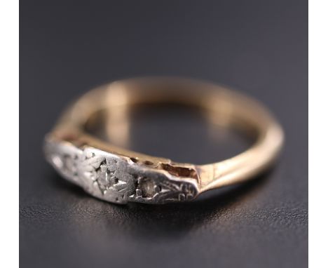 An Art Deco diamond ring, having a central eight cut diamond between two old cut stones pavé-set in precious white metal on a
