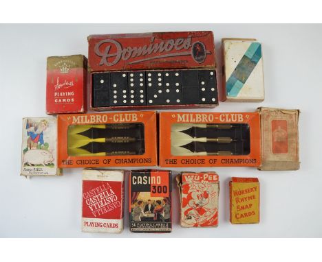 A group of vintage games, comprising playing cards, dominoes and "Milbro-Club" darts