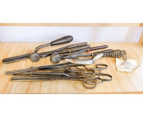 A quantity of 19th Century and later ironing tools comprising two pairs of sleeve iron tongs, five pairs of goffering tongs, 
