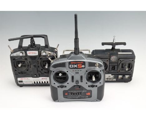 Three radio controllers comprising "Spektrum DX5e", "Techniplus Acoms" and "Arttech R/C Hobby"