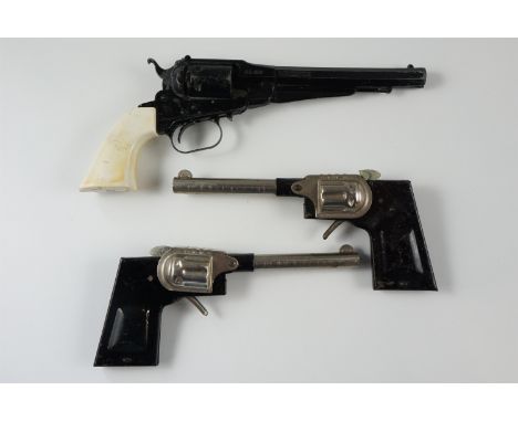Three vintage toy cap guns including a diecast Remington New Model Army