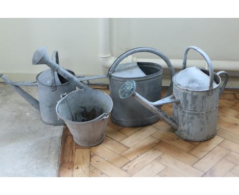 Three vintage galvanized garden watering cans together with a similar bucket, tallest 45.5 cm 