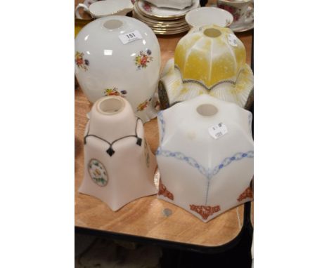 Four early 20th century Art Deco glass light shades with printed and painted patterns.