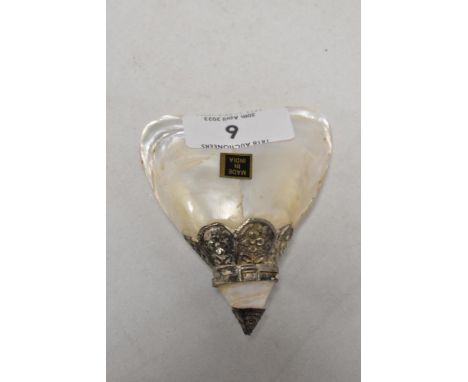 A vintage container made from mother of pearl shell with an Indian silver top.