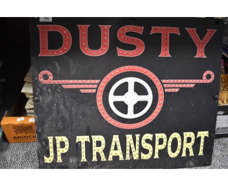 A vintage advertising board for Dusty JP Transport.