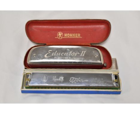 A vintage Hohner Educator II harmonica in original case and a Chinese Tower harmonica