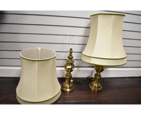 A vintage pair of brass baluster lamp bases with appropriate matching shades. Lamp bases measure 50cm tall without shades.