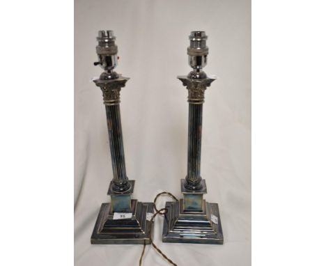 A pair of early 20th century silver plated lamp bases in the form of classical styled candlesticks.
