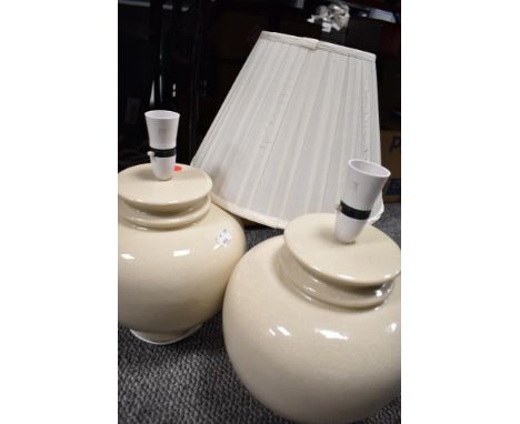 Two large modern ceramic lamp bases in a cream glaze.