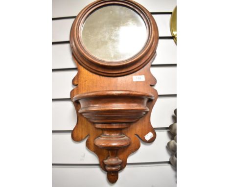 A late Victorian Mahogany hallway mirror in an ecclesiastical design with pocket shelf and formed frame.