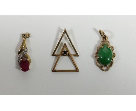 A ruby and diamond pendant, a jade pendant and another pendant 