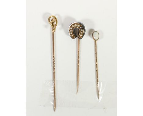 A Victorian gold mounted black onyx and half pearl horseshoe stickpin and two other stickpins, 4.3gm 