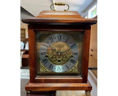 A Franz Helme chiming mantle clock, retailed by Woodford, in a mahogany case with a glazed hinged door, revealing a silvered 
