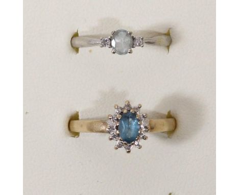 A 9ct white gold aquamarine and diamond three stone ring, N 1/2 and a diamond set cluster ring, N, 4.1gm 