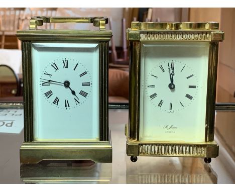 A brass carriage clock, white dial with Roman numerals, St James of London, together with a similar brass carriage clock (2) 