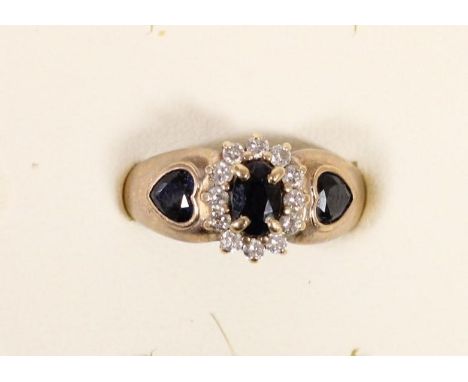 A 9ct gold sapphire and brilliant cut diamond cluster ring with sapphire heart shoulders, N 1/2, 3.3gm 