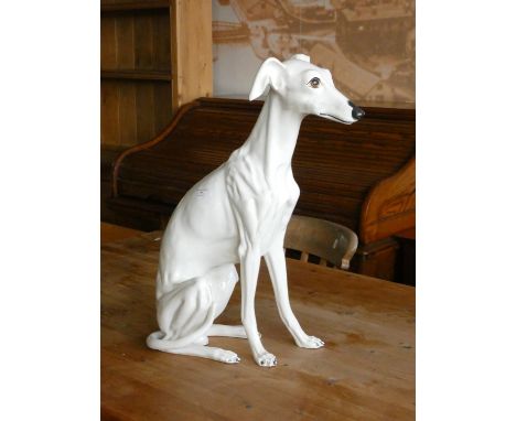 A ceramic fireside model of a seated Whippet dog. 54cm tall.    Additional photo has been added of painters mark