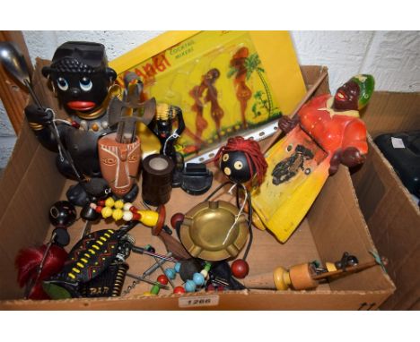 A mid 20th century kitch novelty corkscrew, as a black character, 15cm high; a set of ten novelty cocktail sticks, each figur