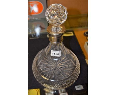 A cut glass ships decanter and stopper, silver collar, Birmingham 1994 (faults)