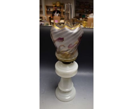 A milk glass oil lamp with frosted shade decorated with iris and winged insects