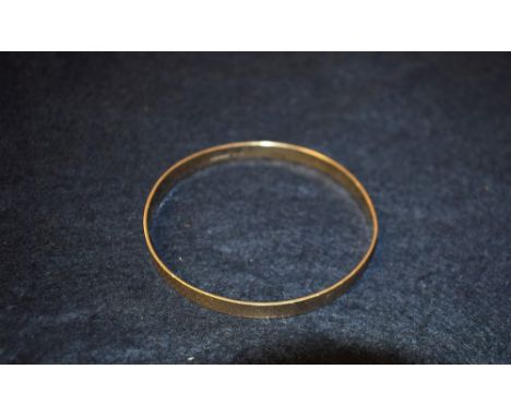 A 9ct gold engine turned bangle. 18.9 grams