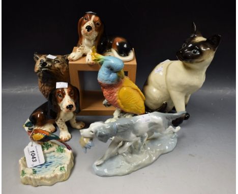 Ceramics - a Nao figure of a sporting dog clutching a partridge; a study of a Siamese cat; a Beswick cockatoo; a Beswick pin 