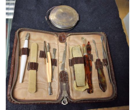 A silver circular powder compact, by KIGU, engine turned, London 1961; a manicure set (2)