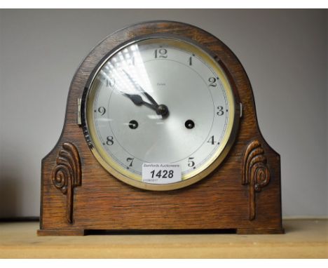 An Enfield oak cased mantel clock, silvered dial
