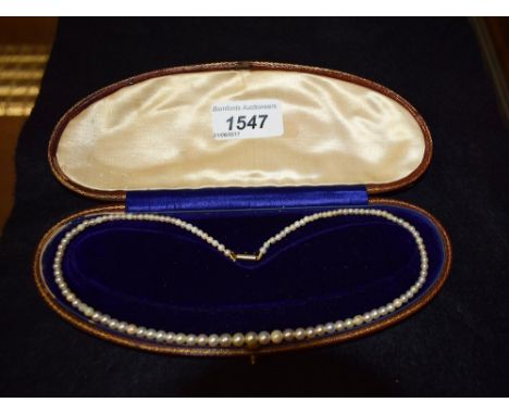 A pearl necklace with 9ct gold fastener, cased