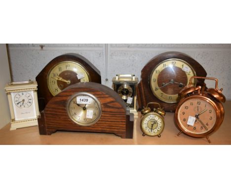 An Art Deco oak cased mantel clock, fan shaped sides; others similar; carriage clocks, alarm clock, etc (7)
