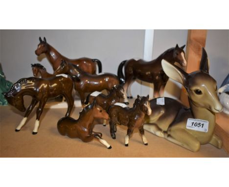 A Beswick figure of a chestnut horse; a Royal Doulton figure of a chestnut horse; a small Beswick horse; a horse group; a Mid